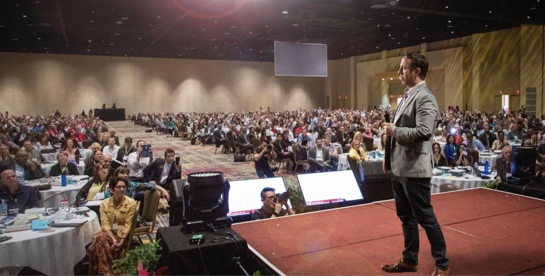 Michael Kimelman addressing a large conference hall